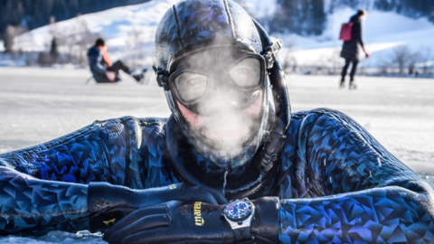 Nik Linder: The last breath before the world record Close-up of a diver looking out of an ice hole, with his breath freezing in front of his face