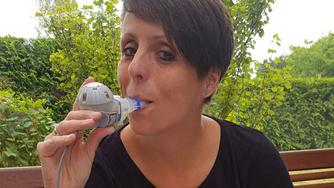 Christine Braune inhaling on her balcony. Christine Braune inhaling on her balcony.