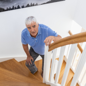 5 common problems in the everyday life of COPD patients: climbing stairs Old man standing on stairs and holding onto the railing