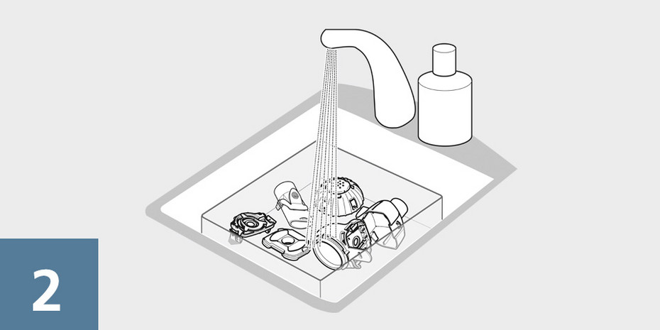eFlow inhale correctly step 2 Nebuliser handset and aerosol head components being rinsed under running water in a sink before assembly.