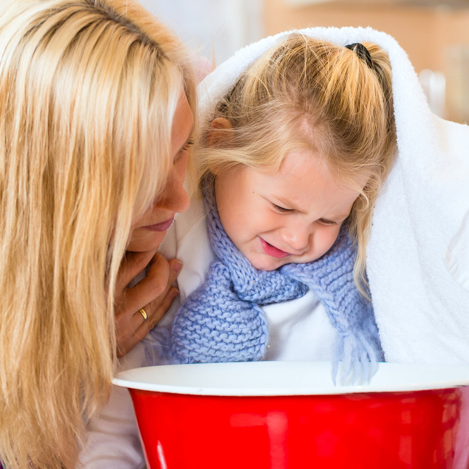Steam inhalation Mother reassures daughter to inhale over a bowl