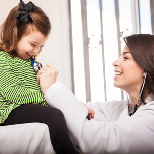 What can be done if a child has mucus in their throat: At the doctor Little girl being examined by doctor