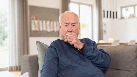 How to ease the symptoms of COPD: tips from the physiotherapist Old men sitting on the couch and coughing into his fist