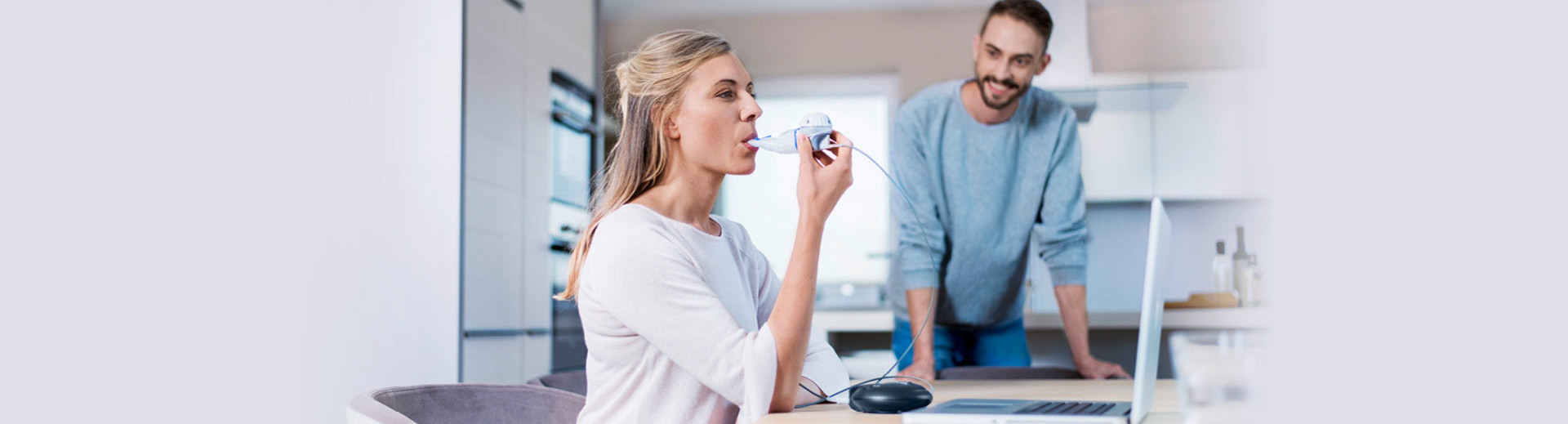 Woman inhales for treatment of cystic fibrosis