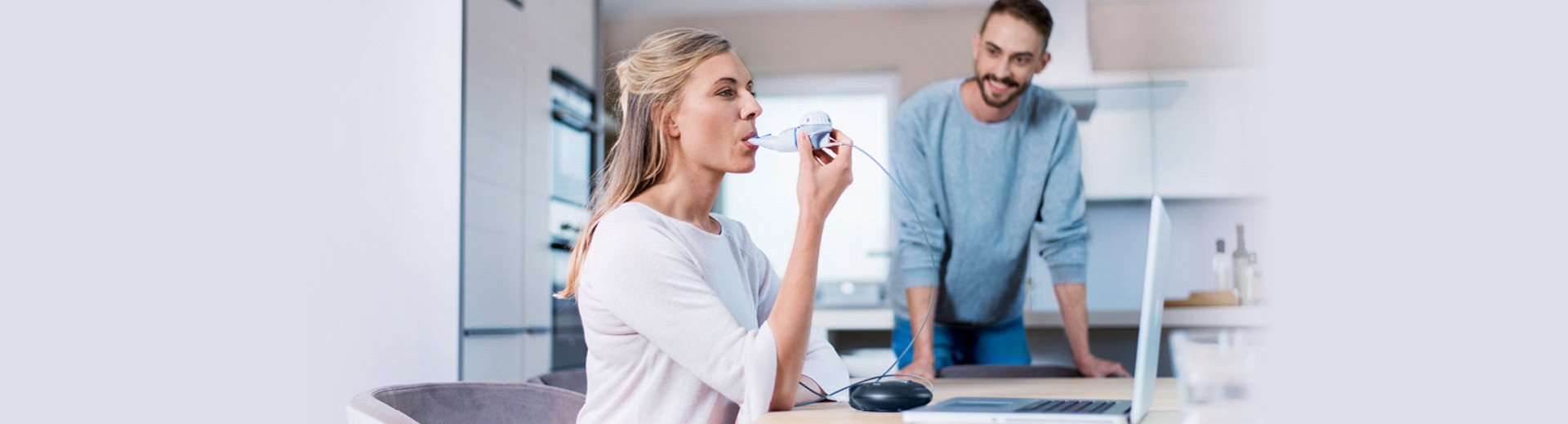 Woman inhales for treatment of cystic fibrosis