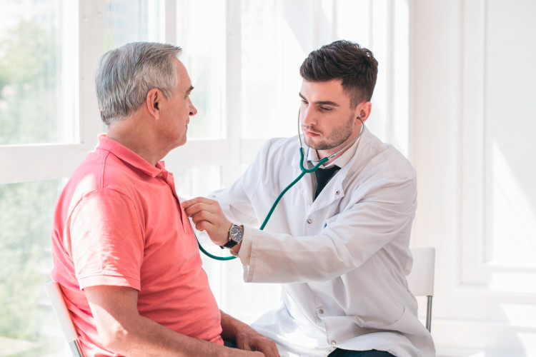 FAQs Inhalation for COPD: Man at the doctor Elderly man being examined by doctor with stethoscope