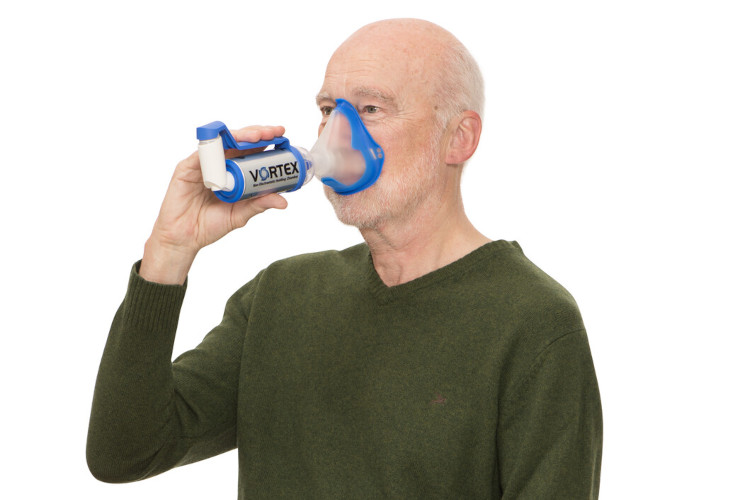 FAQs Inhalation for COPD: VORTEX Elderly man inhales spray with VORTEX