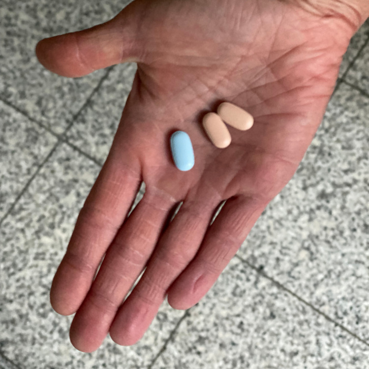 Can you really drop your inhalation therapy altogether if you are on triple CFTR modulators? A cystic fibrosis patient shares her experience Close-up of an outstretched hand with a blue and two red tablets in the palm of the hand